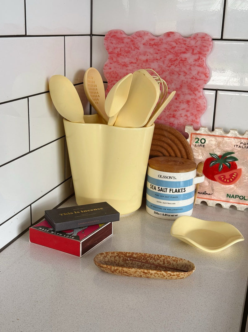 The Butter Bunch Holder with a Spoon Rest on the bench